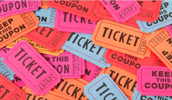 Colorful admit-one style cinema tickets scattered in a pile